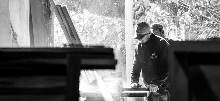 AKL Home craftsperson shaping furniture by hand